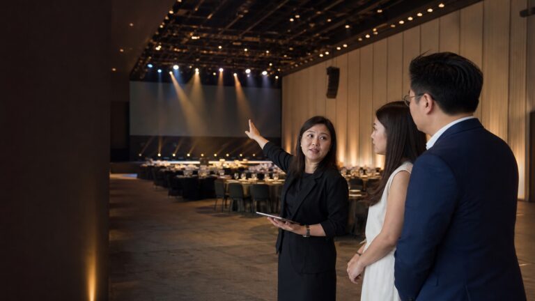 Event organiser briefing corporate clients during a Singapore venue walkthrough