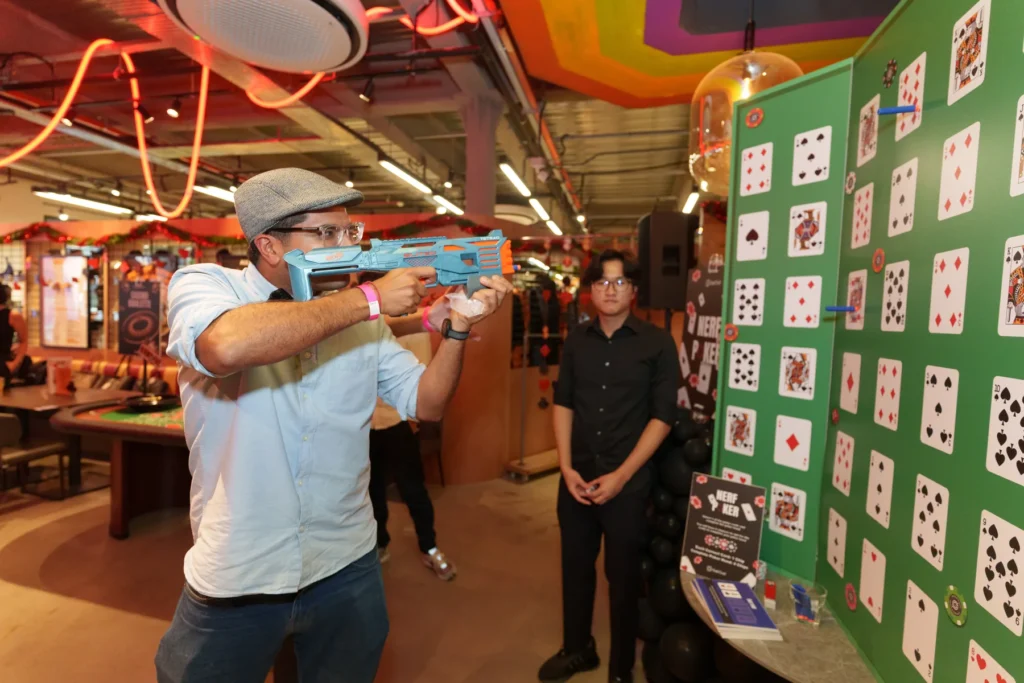 Guests taking part in an interactive activity at a Get Out! Events corporate year-end party in Singapore