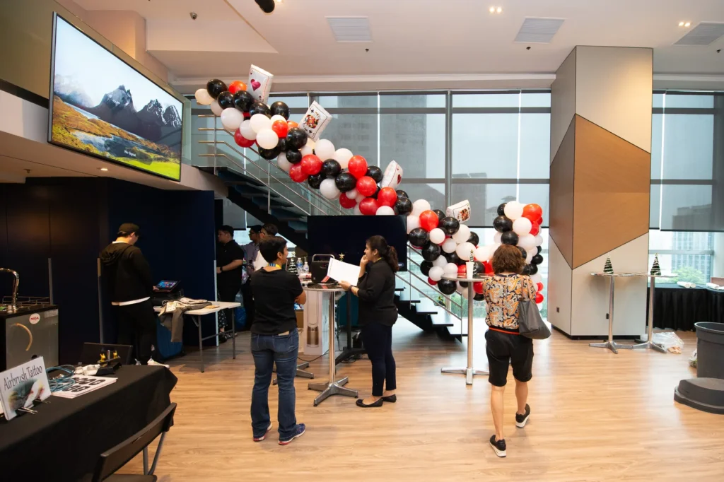 Corporate Christmas party venue with festive balloon installation and activity stations in Singapore