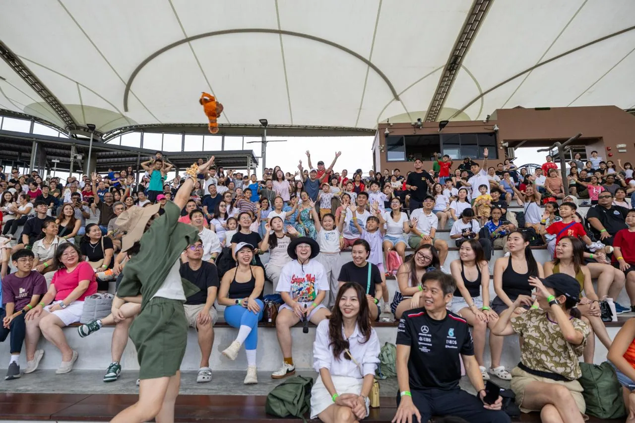 Families gathered together in a covered amphitheatre during a family day