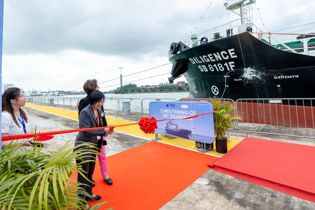 Ribbon-cutting ceremony beside a vessel at a ship christening